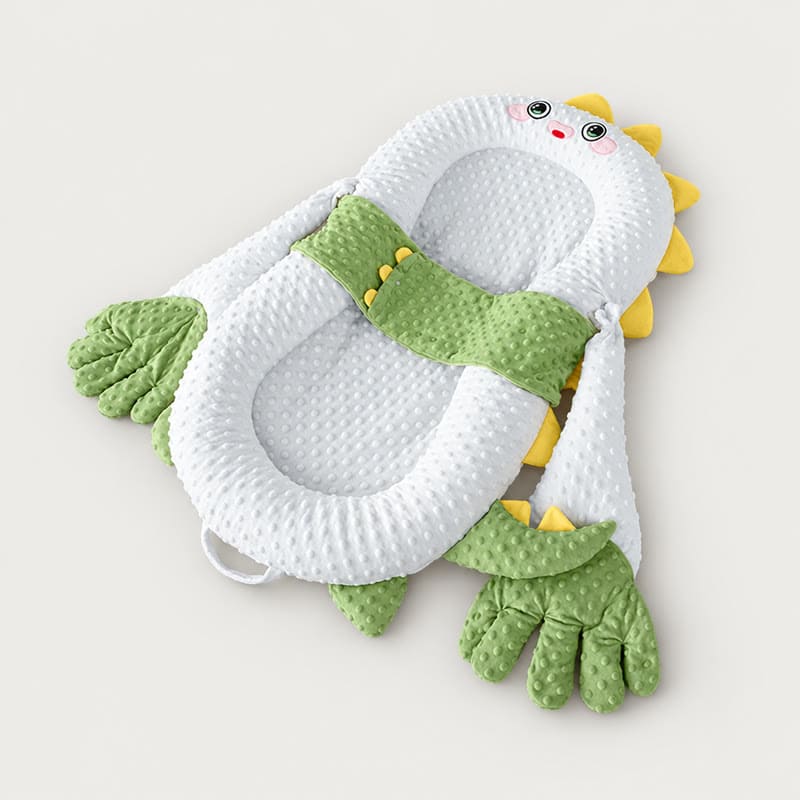 Green dino soothing patting Yorkie bed
