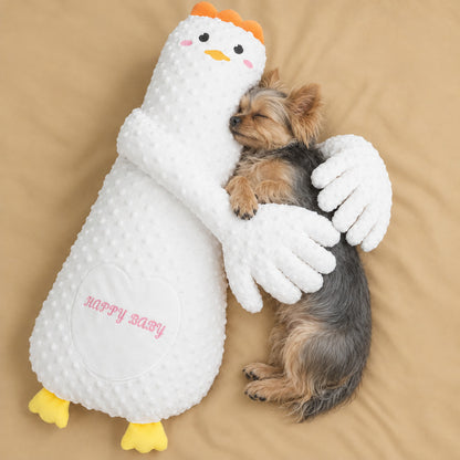Yorkie sleeping in the arms of the white goose patting pillow