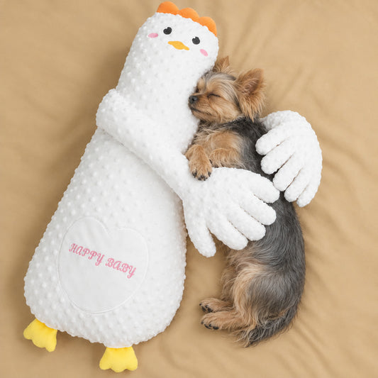 Yorkie sleeping in the arms of the white goose patting pillow