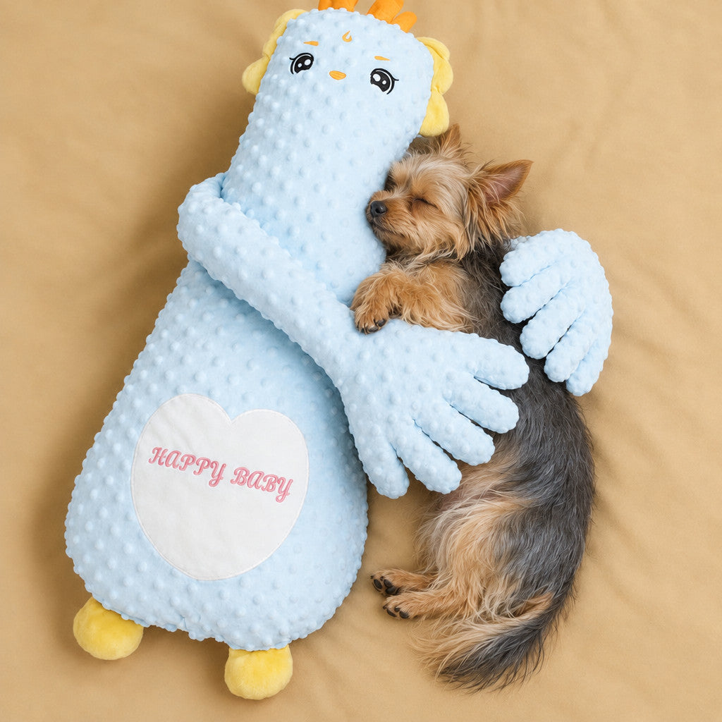 Yorkie sleeping in the arms of the blue dragon patting pillow